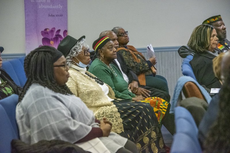 The audience listens to Fleur McKendell as she inspires them to fight for justice.